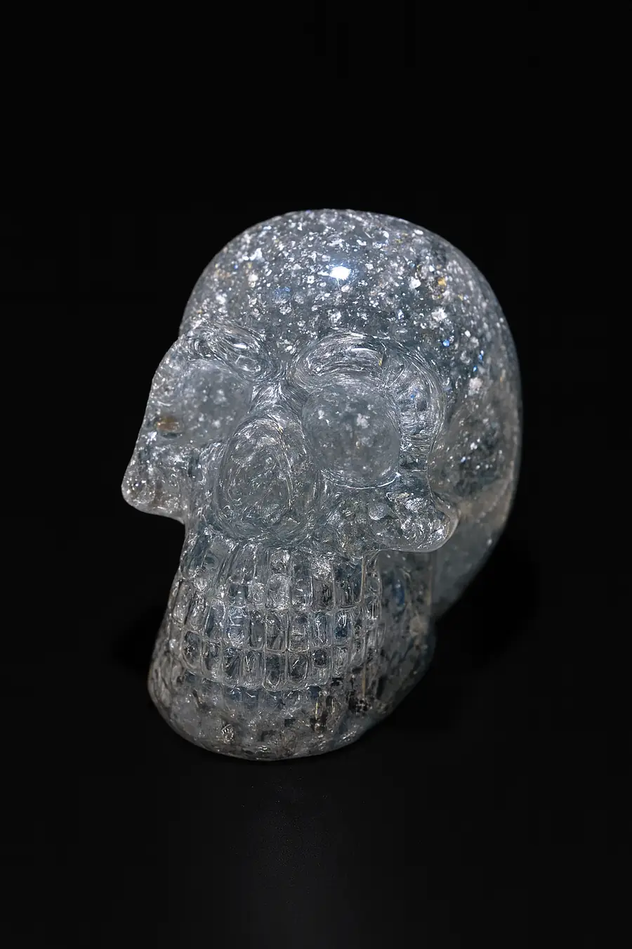A close-up photograph features a crystal skull scu