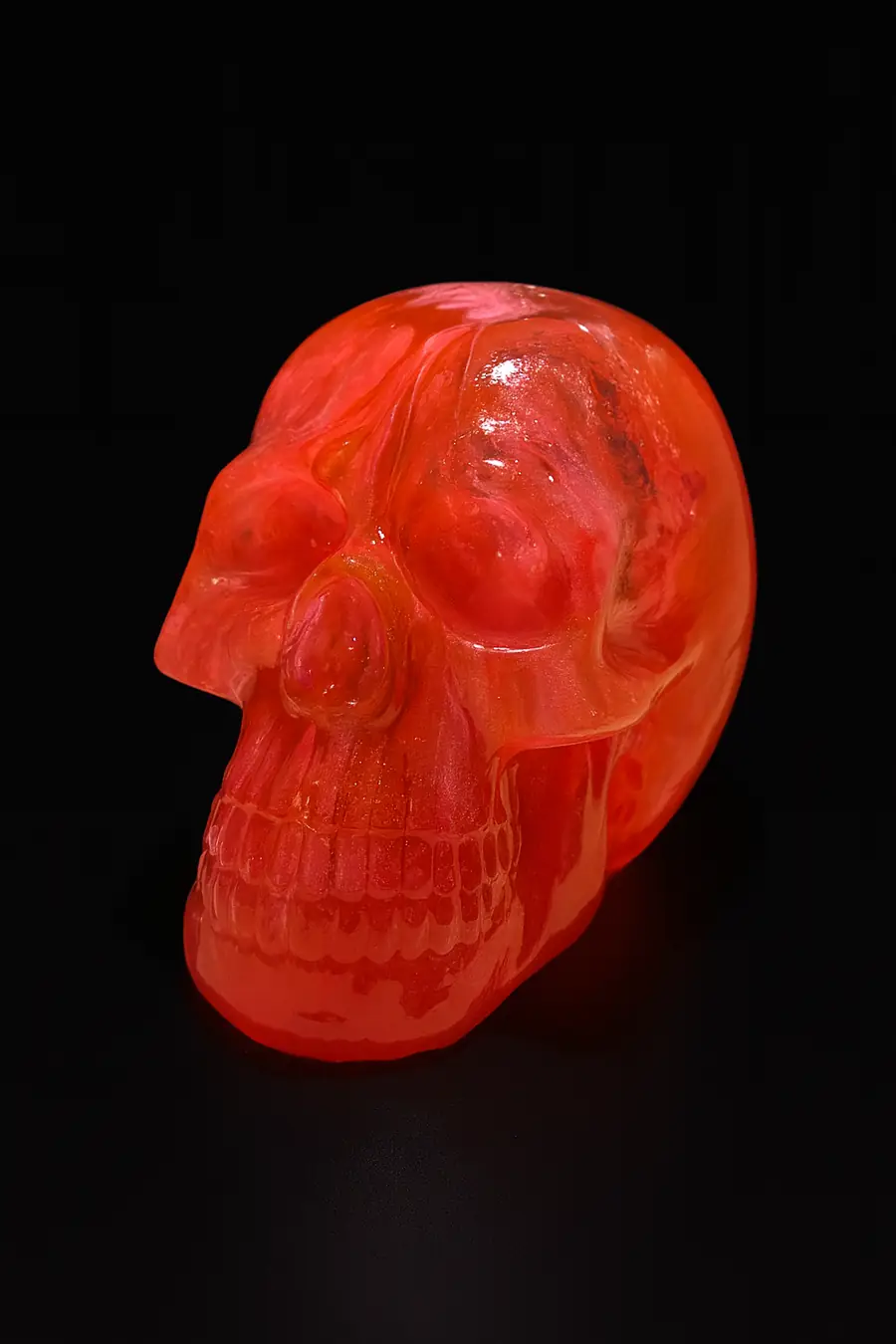 A photograph features a translucent red skull figu